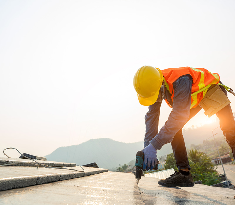 person working on a construction project using a tool on a sloped surface representing 5 key steps in building